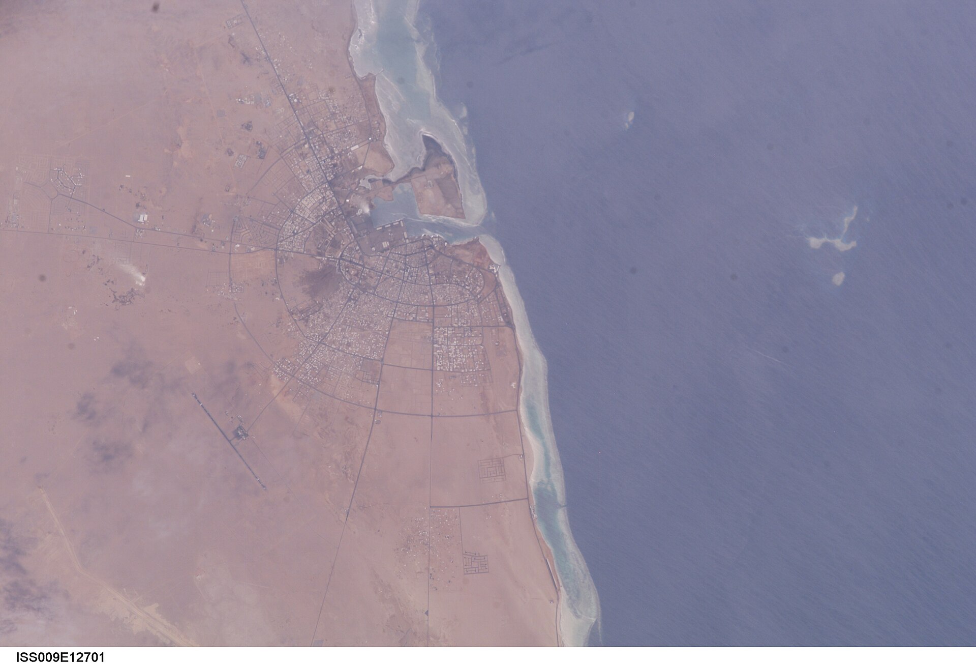 NASA ISS photograph of Yanbu al Bahr showing the city grid and Red Sea coastline where Saudi Arabia routes crude oil exports via the East-West Petroline