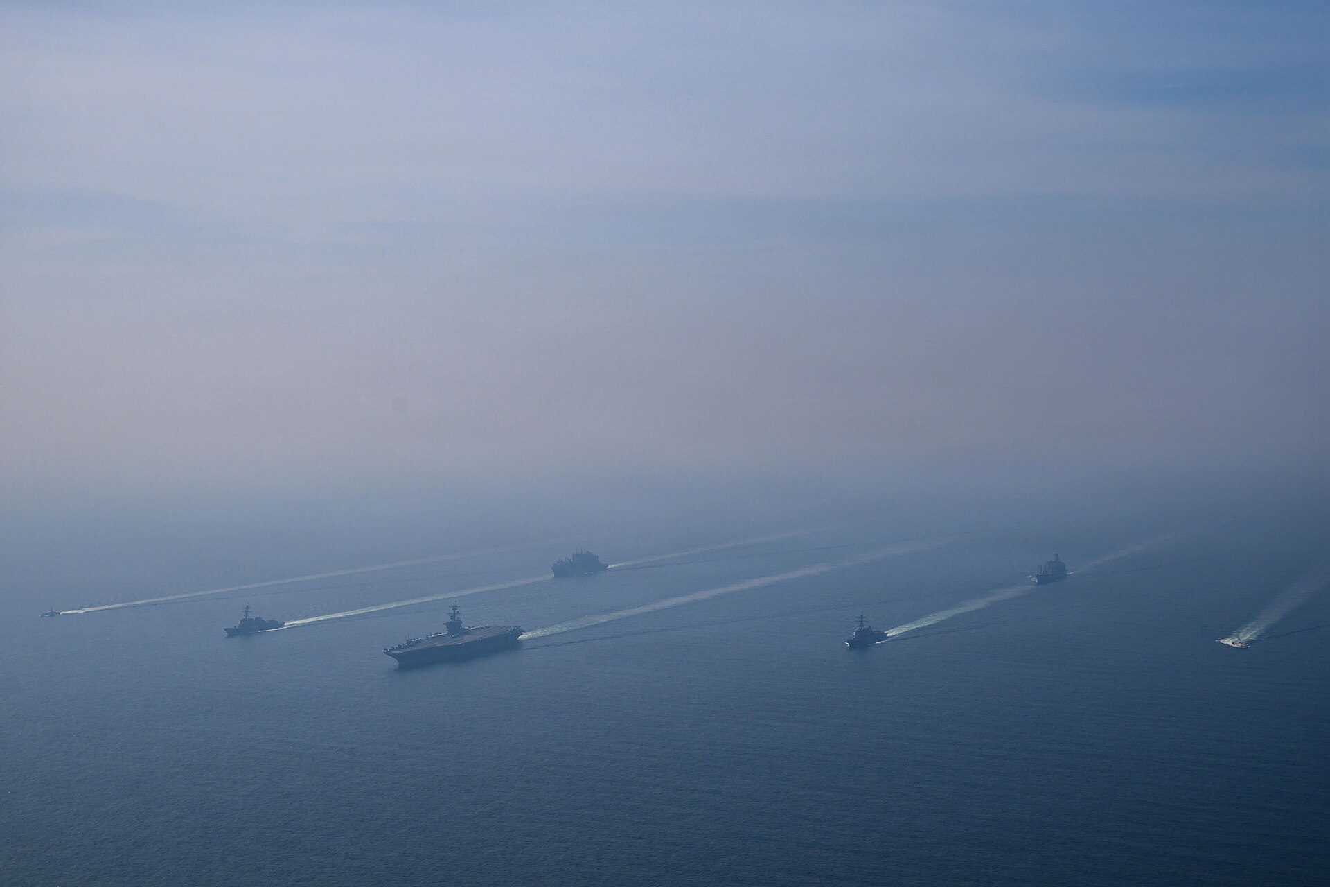 USS Abraham Lincoln carrier strike group underway in 2026, with guided-missile destroyers in formation