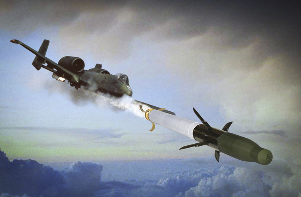 An A-10 aircraft fires an APKWS-II Advanced Precision Kill Weapon System laser-guided rocket, showing the distinctive white mid-body guidance section that converts an unguided Hydra 70 into a precision munition