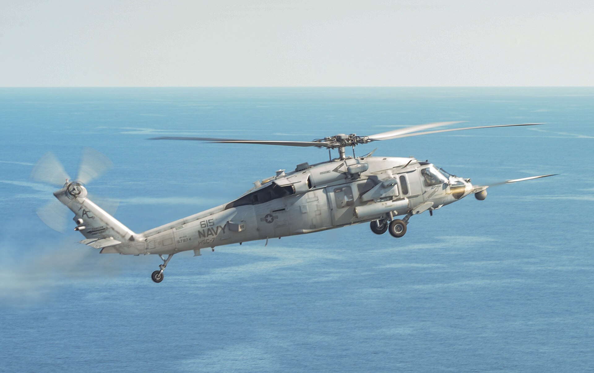 US Navy MH-60S Sea Hawk helicopter HSC-7 fires an APKWS-II Advanced Precision Kill Weapon System round during live fire qualification exercise off the Virginia coast August 2015