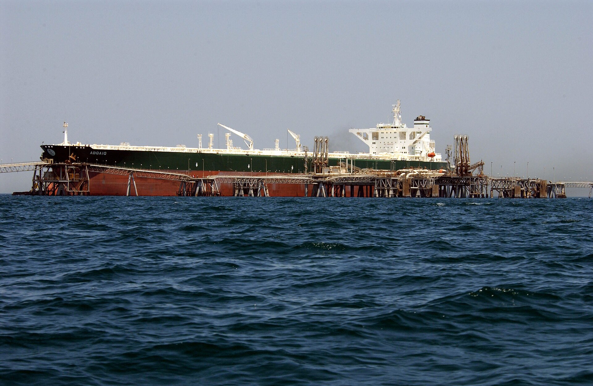Aramco supertanker AbQaiq receives crude oil at an offshore Gulf loading terminal — at 2 million barrels per loading, the economics of every Ras Tanura cargo are now set by the July OSP cut