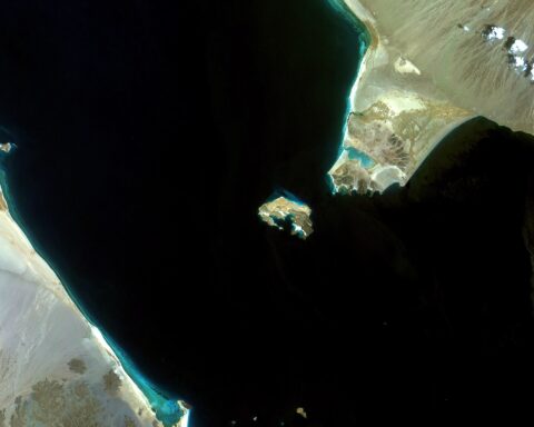 Satellite view of the Bab al-Mandeb strait between Yemen and Djibouti, showing the 32-kilometre choke point through which 12 percent of global trade transits