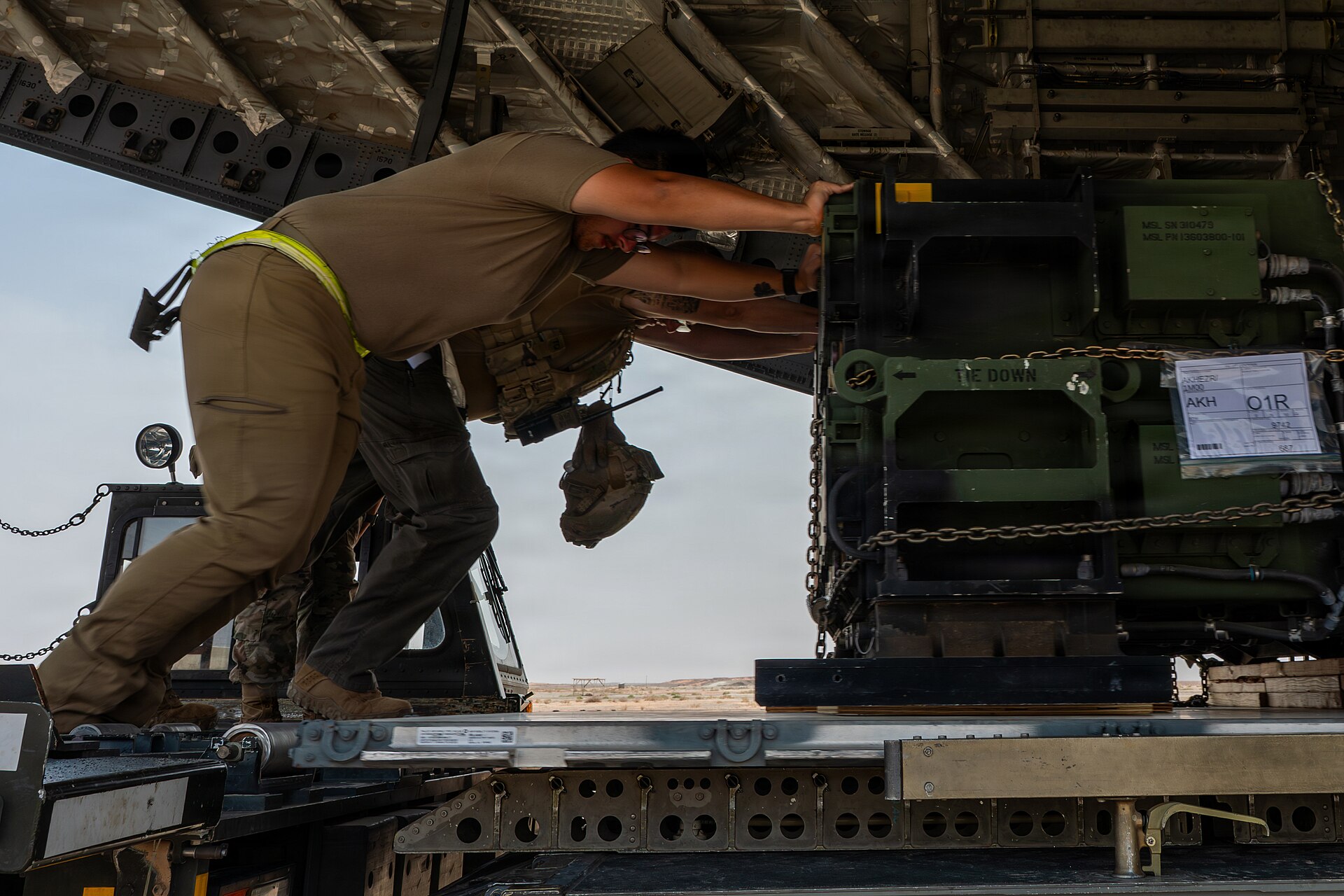 US Air Force airmen load military cargo onto a C-17 Globemaster III at a base in the CENTCOM area of operations during Operation Epic Fury, April 2026