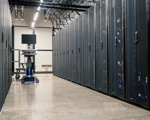 Data center server hall with rows of rack-mounted servers — the type of hyperscale infrastructure targeted by IRGC cruise missiles in Wave 24