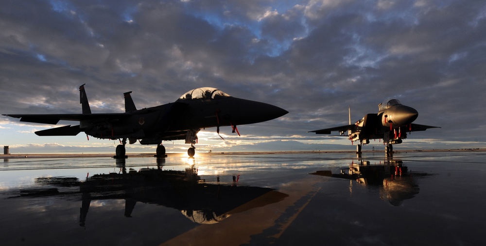 F-15E Strike Eagle aircraft on the flight line at dusk, dual-role fighters assigned to the 391st and 389th Fighter Squadrons