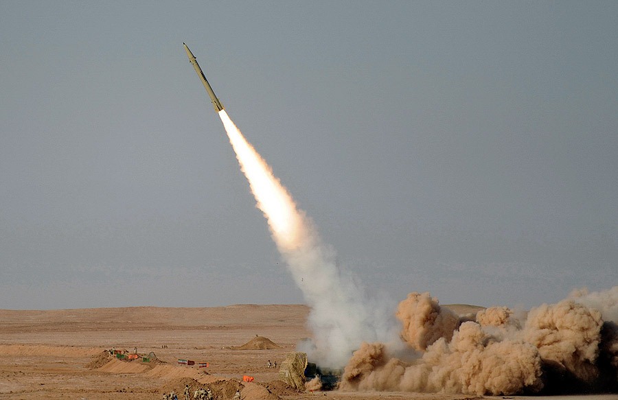 Iranian Fateh-110 ballistic missile launching from a desert test site — the parent weapon of the Burkan-series missiles Houthis have fired at Saudi targets since 2017, including a 2017 test against Yanbu refinery