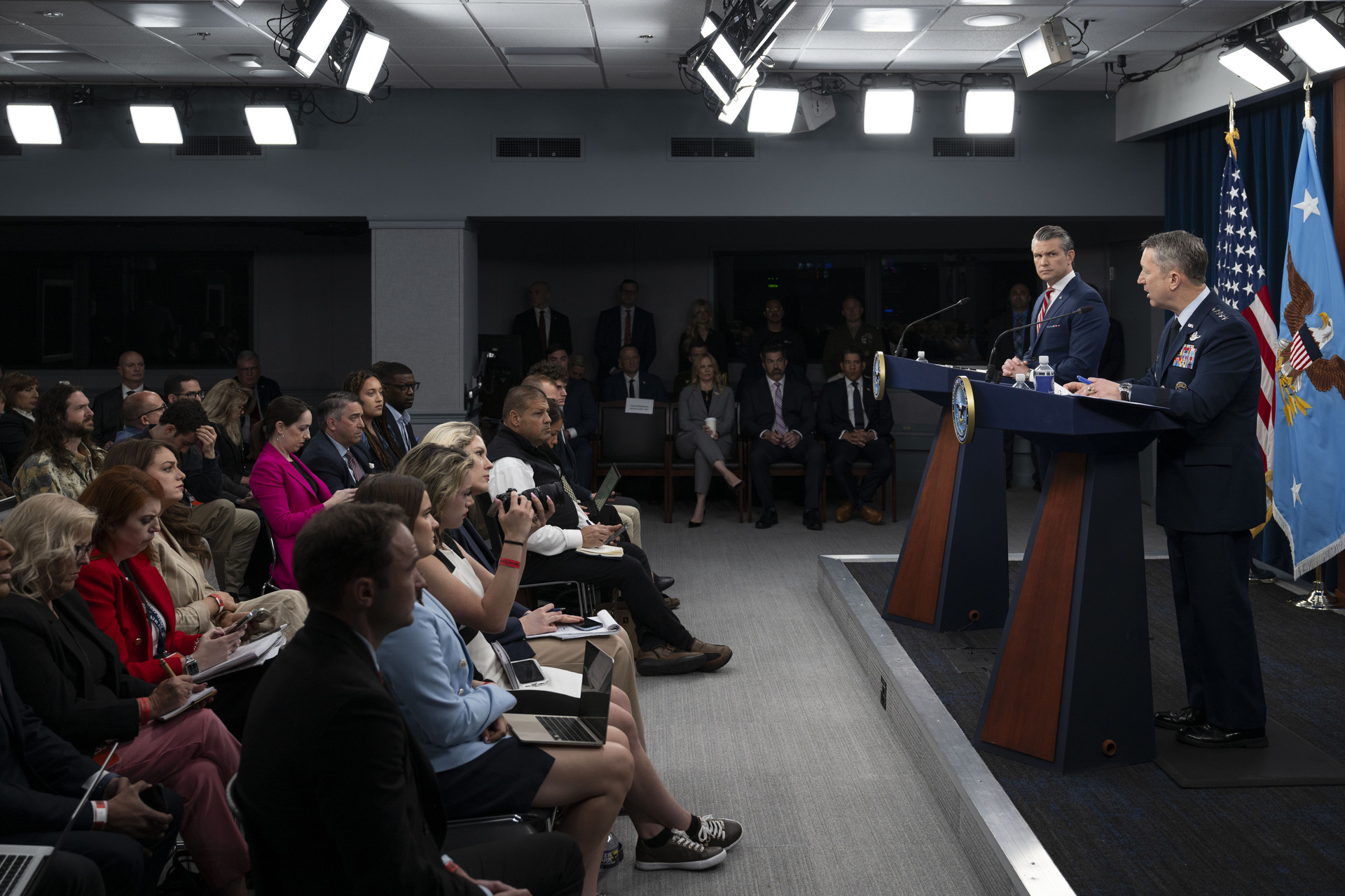 U.S. Defense Secretary Pete Hegseth and Joint Chiefs Chairman Gen. Dan Caine at a Pentagon press briefing, May 5, 2026. Photo: Staff Sgt. Madelyn Keech / U.S. Air Force / Public Domain
