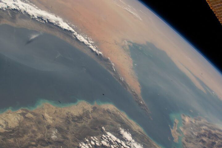 Strait of Hormuz seen from the International Space Station, showing the narrow chokepoint between Iran and Oman where commercial shipping transits the Persian Gulf