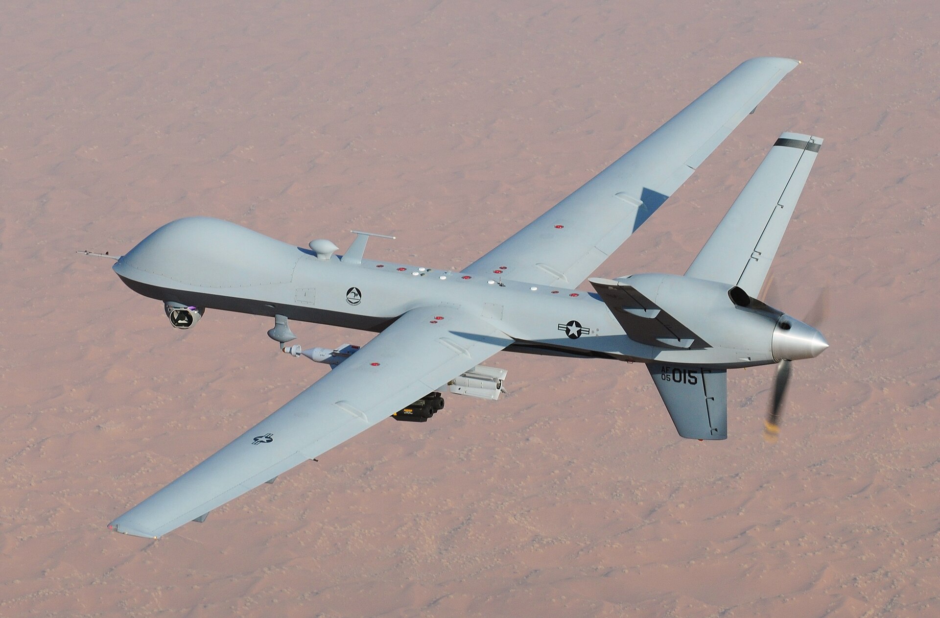 US Air Force MQ-9 Reaper unmanned aerial vehicle in flight over desert terrain