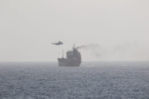 Iranian military helicopter hovers over merchant tanker MT Wila in the Arabian Gulf as IRGC naval forces conduct a boarding operation, August 2020