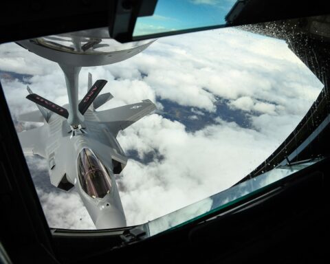 An F-35A Lightning II connects to the flying boom of a KC-135 Stratotanker during aerial refueling. Prince Sultan Air Base operates thirteen KC-135s that sustain US air operations over the Gulf — the fleet that makes Nasr-2 targeting decisions about PSAB strategically consequential.