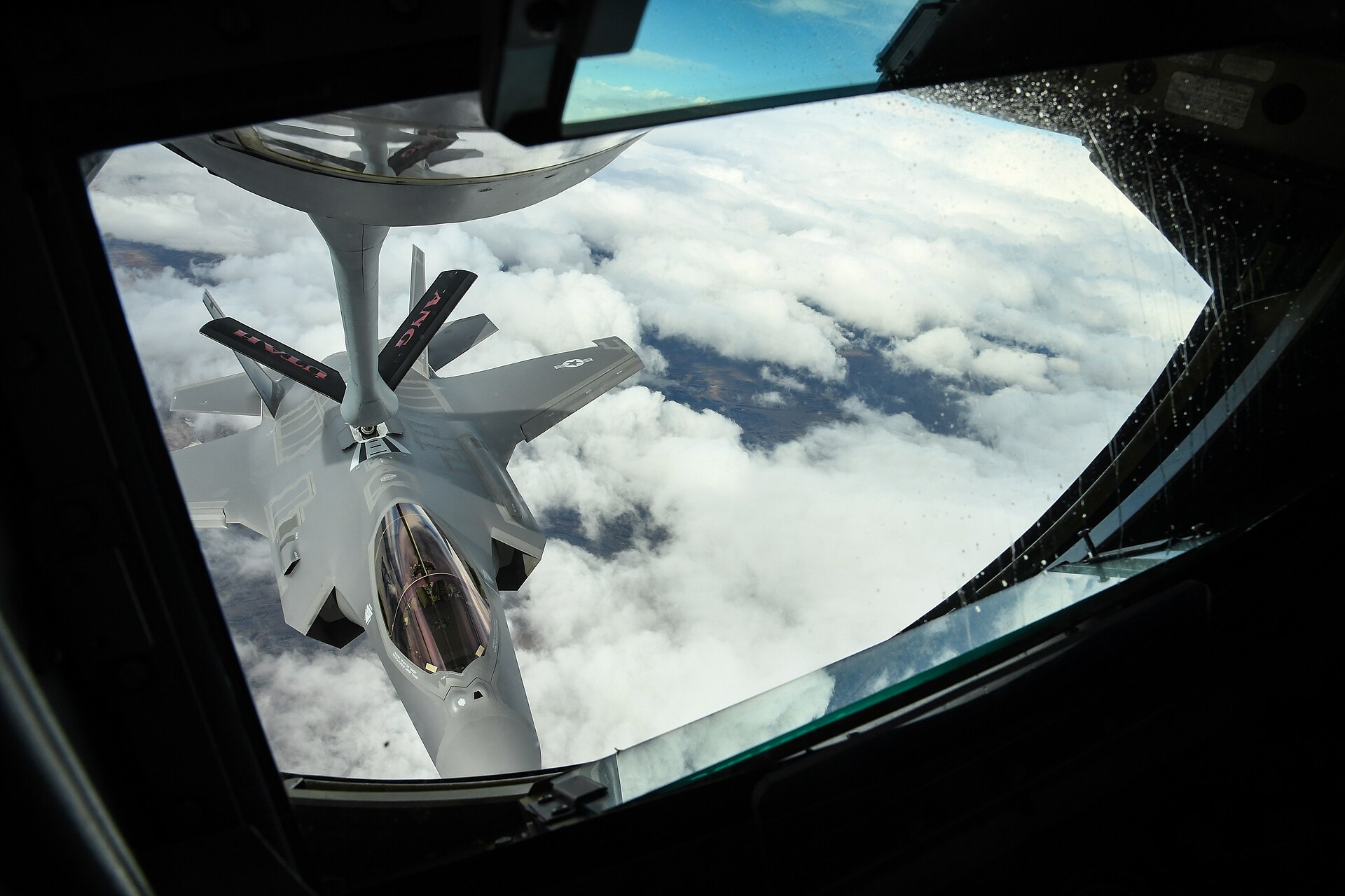 An F-35A Lightning II connects to the flying boom of a KC-135 Stratotanker during aerial refueling. Prince Sultan Air Base operates thirteen KC-135s that sustain US air operations over the Gulf — the fleet that makes Nasr-2 targeting decisions about PSAB strategically consequential.
