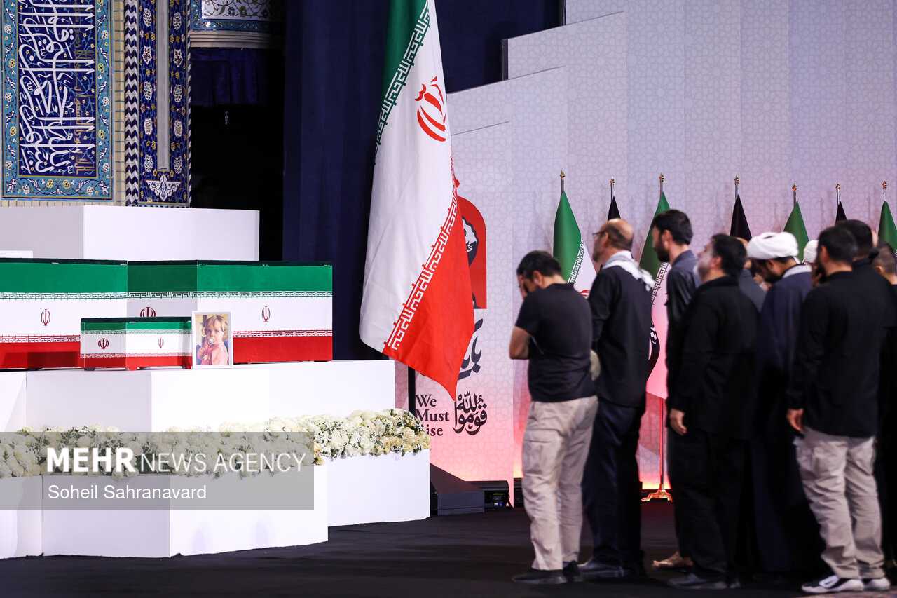 Caskets and mourners at the state tribute ceremony for Ali Khamenei, Tehran, July 2026. Iranian flags draped over the coffins as delegations pay formal respects. Photo: Mehr News Agency / Soheil Sahranavard / CC BY 4.0