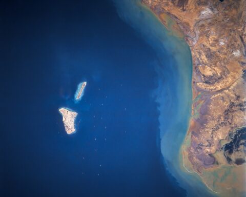 Kharg Island in the Persian Gulf — Iran's primary crude oil export terminal — with tankers visible in surrounding waters. NASA satellite photograph, Space Shuttle mission STS-055.