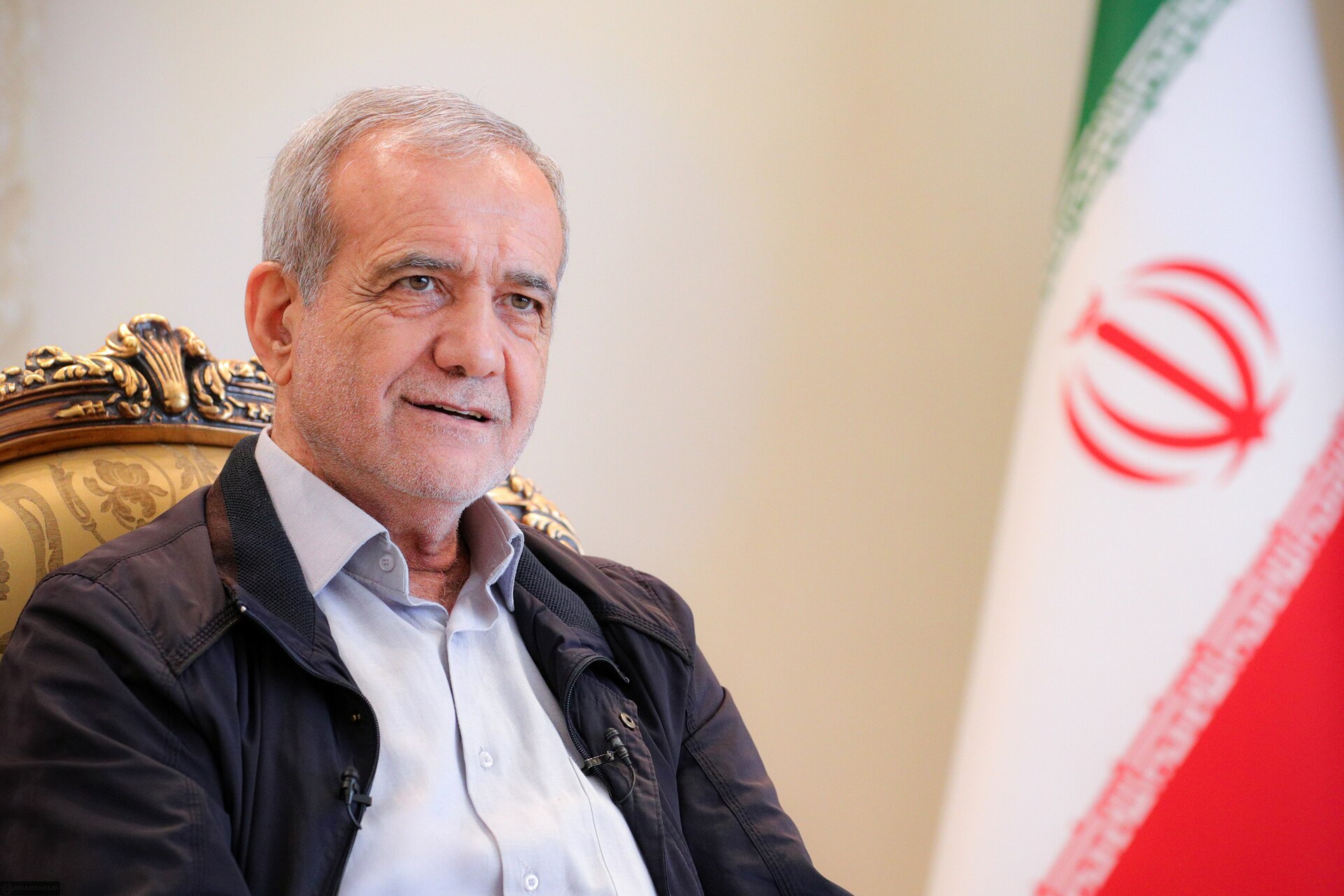 Iranian President Masoud Pezeshkian, who signed the Islamabad MOU on June 17-18, 2026, photographed in a formal setting with the Iranian flag. Pezeshkian was pelted with rocks at Khamenei's father's funeral on July 13 by crowds chanting death to the compromiser.