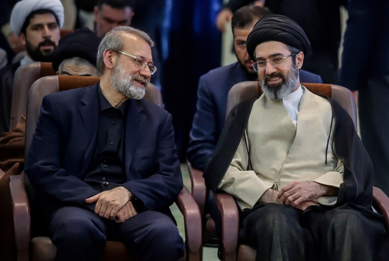 Mojtaba Khamenei (right) in conversation with Ali Larijani at an official Iranian government function — Mojtaba holds sole Article 176 ratification authority over any SNSC decision, including the Islamabad MOU