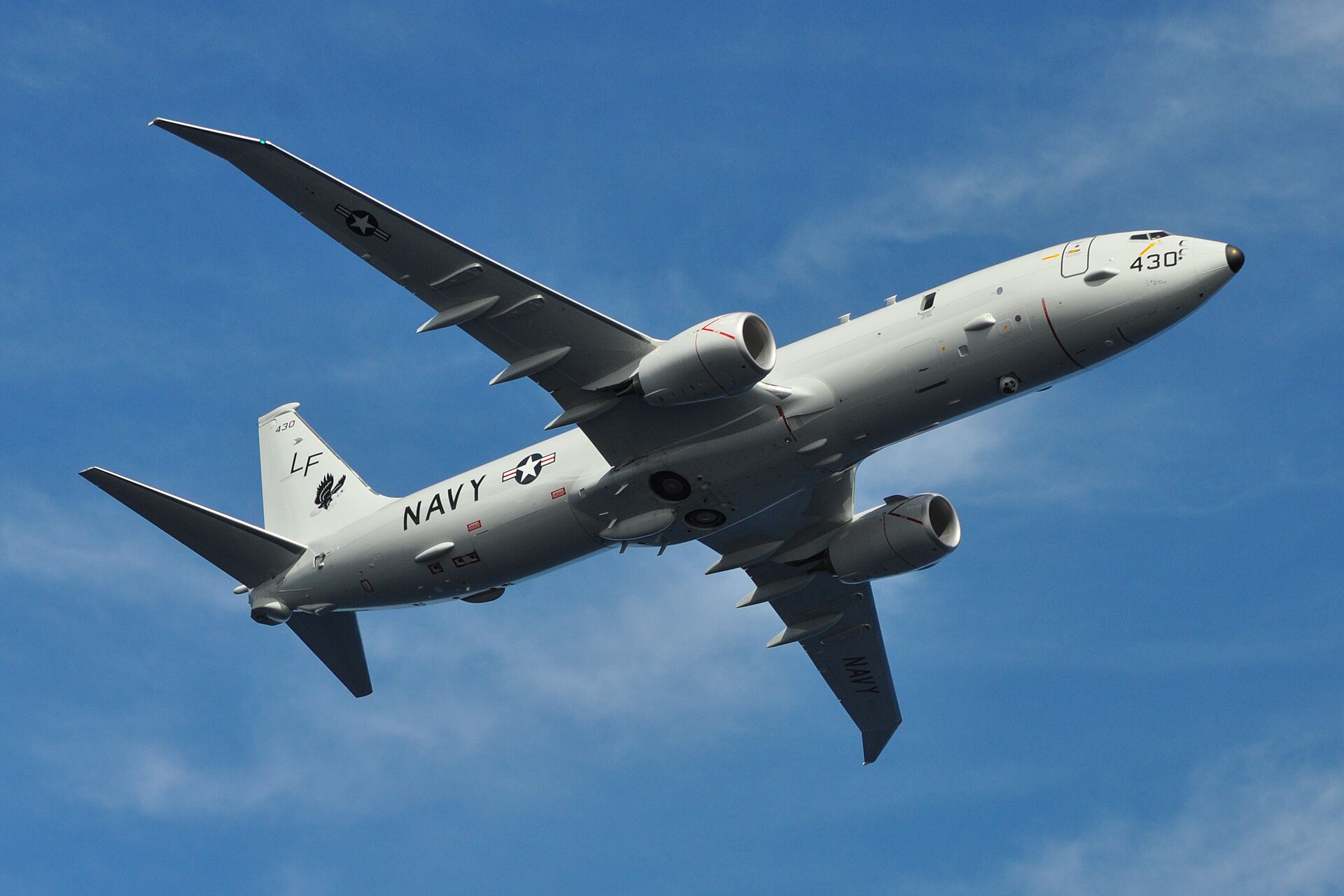 US Navy P-8A Poseidon maritime patrol aircraft in flight, showing sensor dome and twin-engine configuration used for Gulf surveillance operations