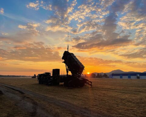 US Army Patriot missile launcher on deployment, silhouetted against a sunrise sky — the same type of interceptor system now at 86% depletion in Saudi Arabia
