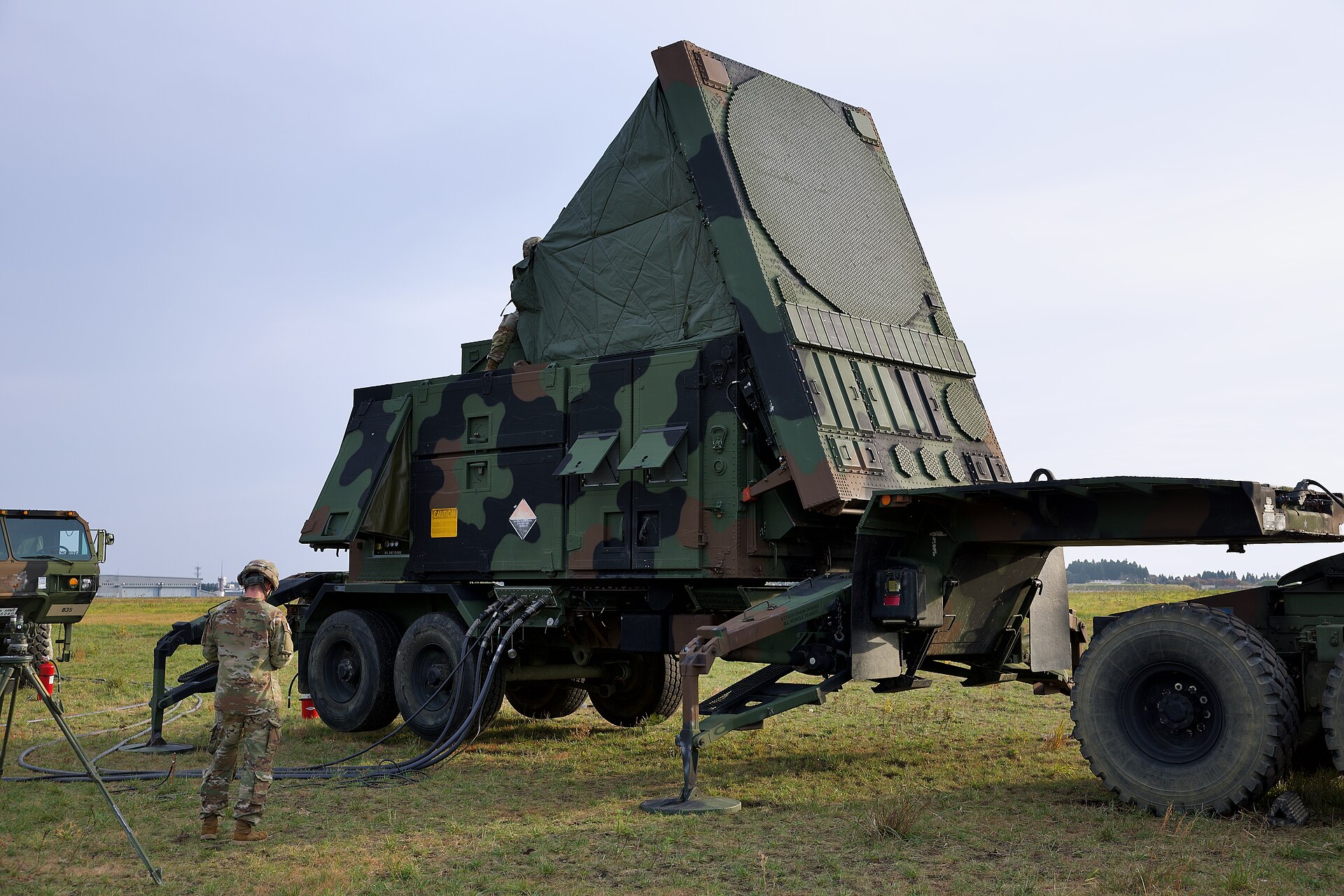 A US Army soldier conducts pre-activation checks on an AN/MPQ-65 Patriot radar array during Keen Sword 25 at Misawa Air Base, Japan — the same radar system integrated into the Saudi Patriot battery network protecting critical infrastructure against Iranian ballistic missiles