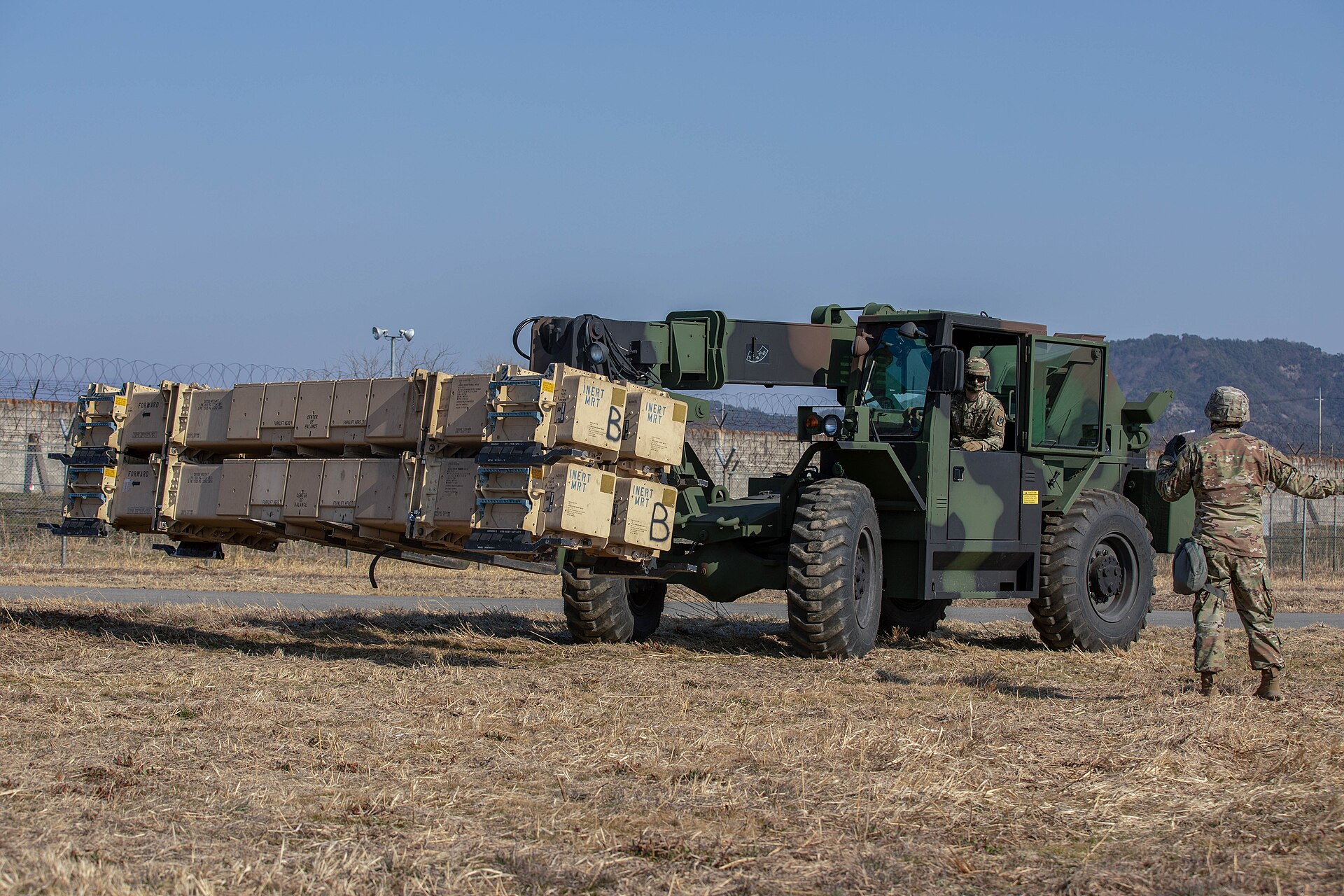 US soldiers move Patriot missile ammunition canisters during training. Lockheed Martin's sole PAC-3 MSE production facility in Camden, Arkansas produces approximately 600 rounds per year for all customers worldwide — a rate that cannot replenish Saudi Arabia's depleted stockpile before mid-2027.