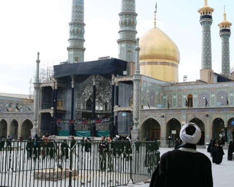 Exterior of the Fatima Masumeh Shrine in Qom, Iran, with its distinctive golden dome and minarets, the religious center that Pezeshkian visited on June 28 2026 to seek clerical legitimacy for the Islamabad MOU