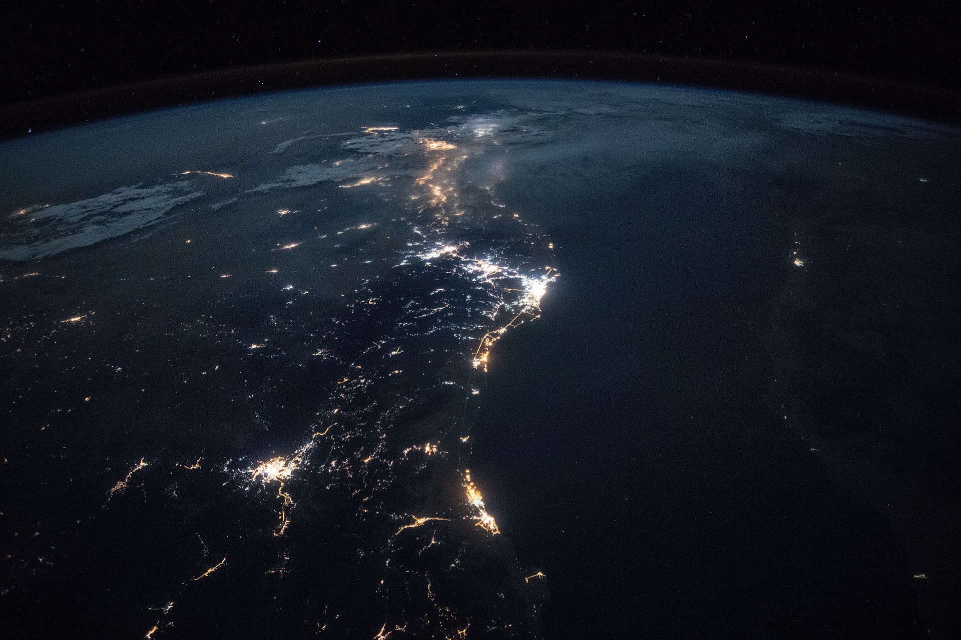 Saudi Arabia's Red Sea coast at night photographed from the International Space Station during Expedition 55, showing city lights along the coastal corridor including the Yanbu industrial port city where the East-West Petroline terminates