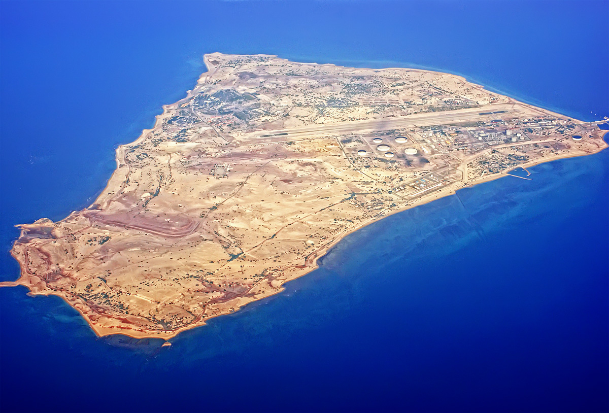 Aerial photograph of Sirri Island in the Persian Gulf, Iran, showing airstrip, oil storage tanks and port facilities — one of several Iranian islands in the Hormuz operational theater