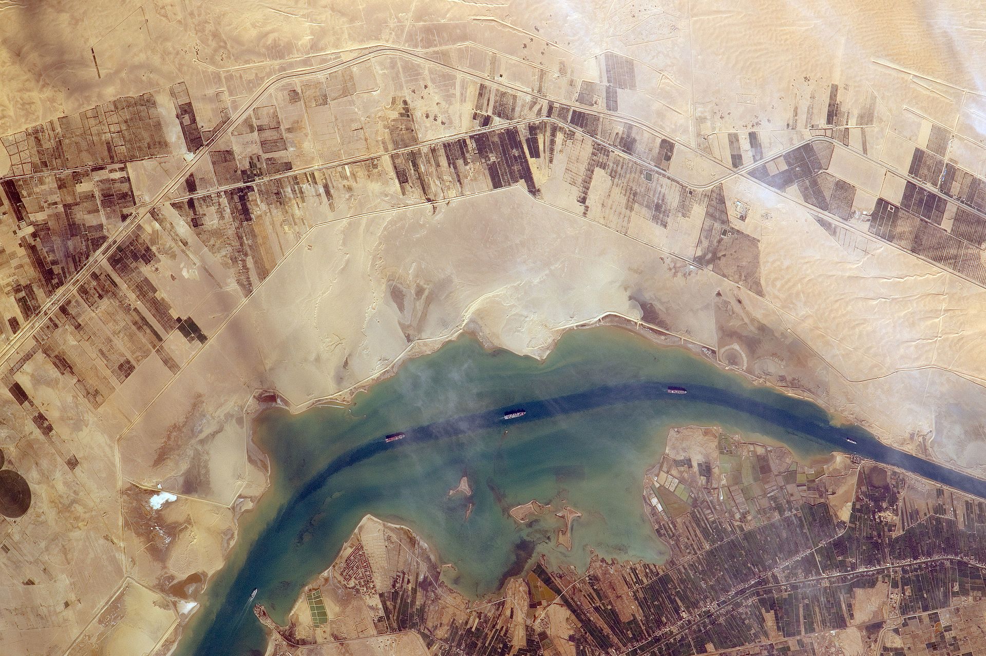 Ships transit the Suez Canal near Port Said photographed from the International Space Station — Houthi attacks diverted 60 percent of Red Sea commercial traffic via the Cape of Good Hope route adding 10 to 14 days per voyage