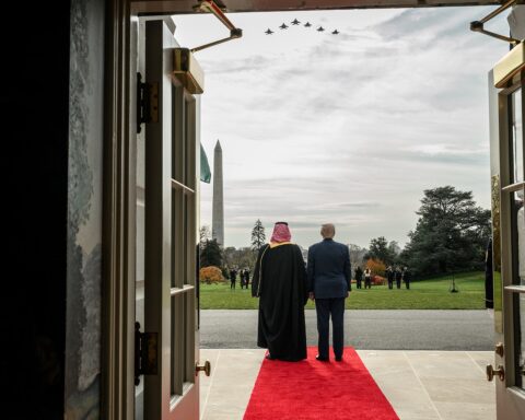 Trump and MBS on White House South Lawn red carpet with military jets flying overhead, November 2025