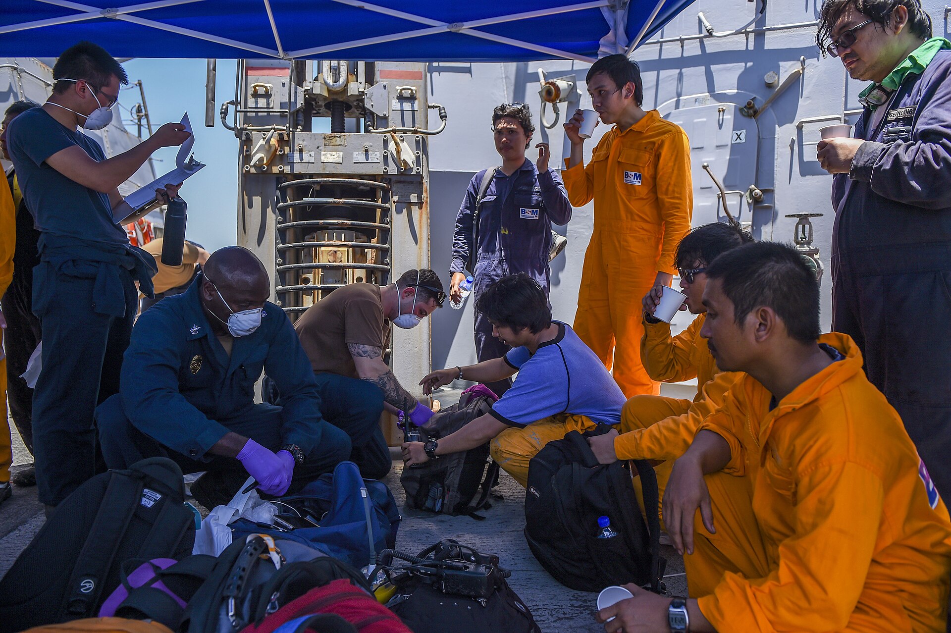 US Navy sailors aboard USS Bainbridge render aid to crew of the chemical tanker MV Kokuka Courageous in the Gulf of Oman following an Iranian mine attack in June 2019