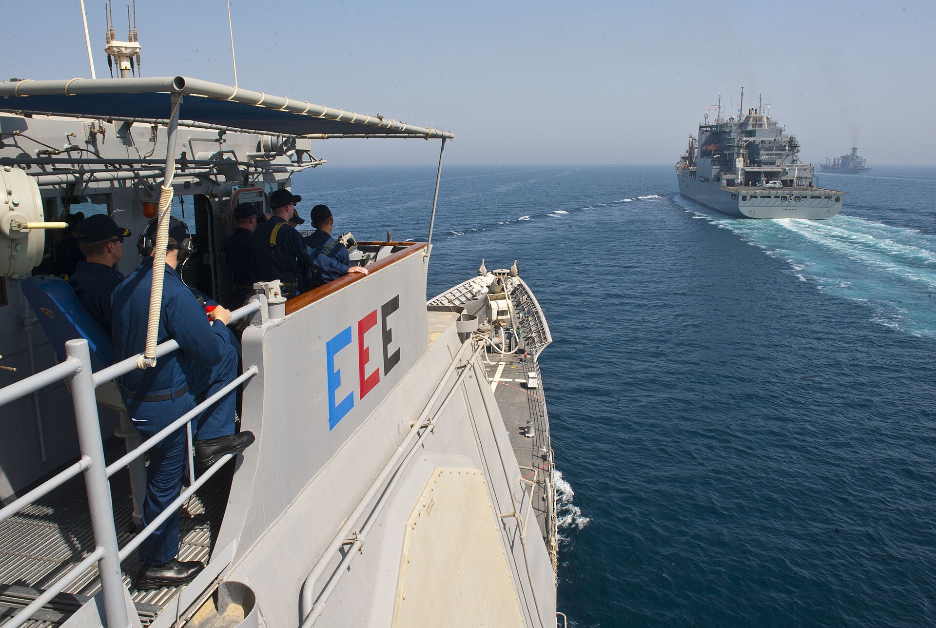 USS Cape St. George guided-missile cruiser alongside USNS Charles Drew in the Arabian Gulf, representing US naval presence in the Persian Gulf region