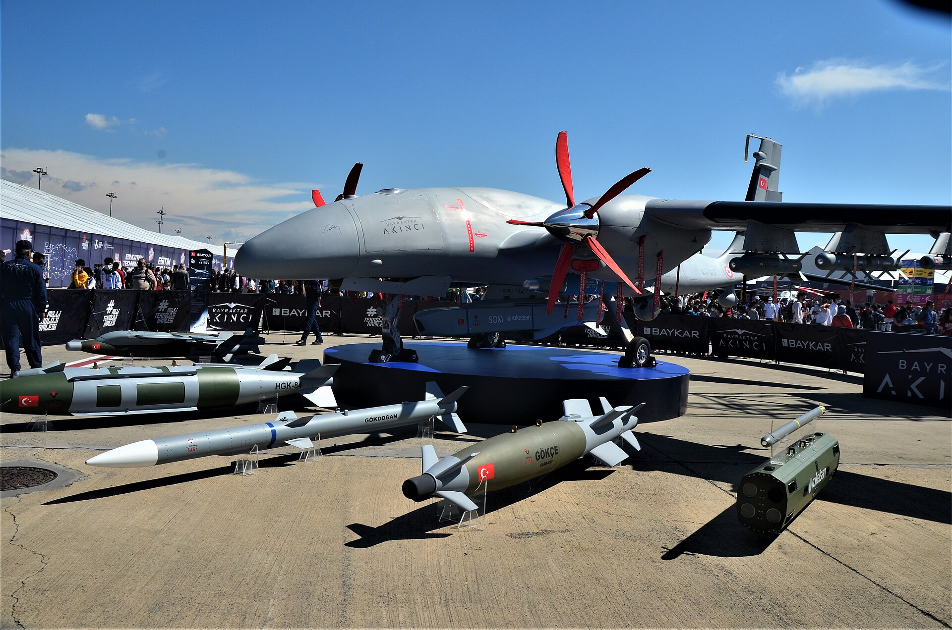 Baykar Bayraktar Akinci heavy combat UCAV on display at Teknofest 2021 with associated weapons including the HGK-8 precision glide kit and Gokdogan air-to-air missile. Saudi Arabia signed a roughly €3 billion deal for approximately sixty Akinci drones in 2023, with first locally assembled units expected in 2026.