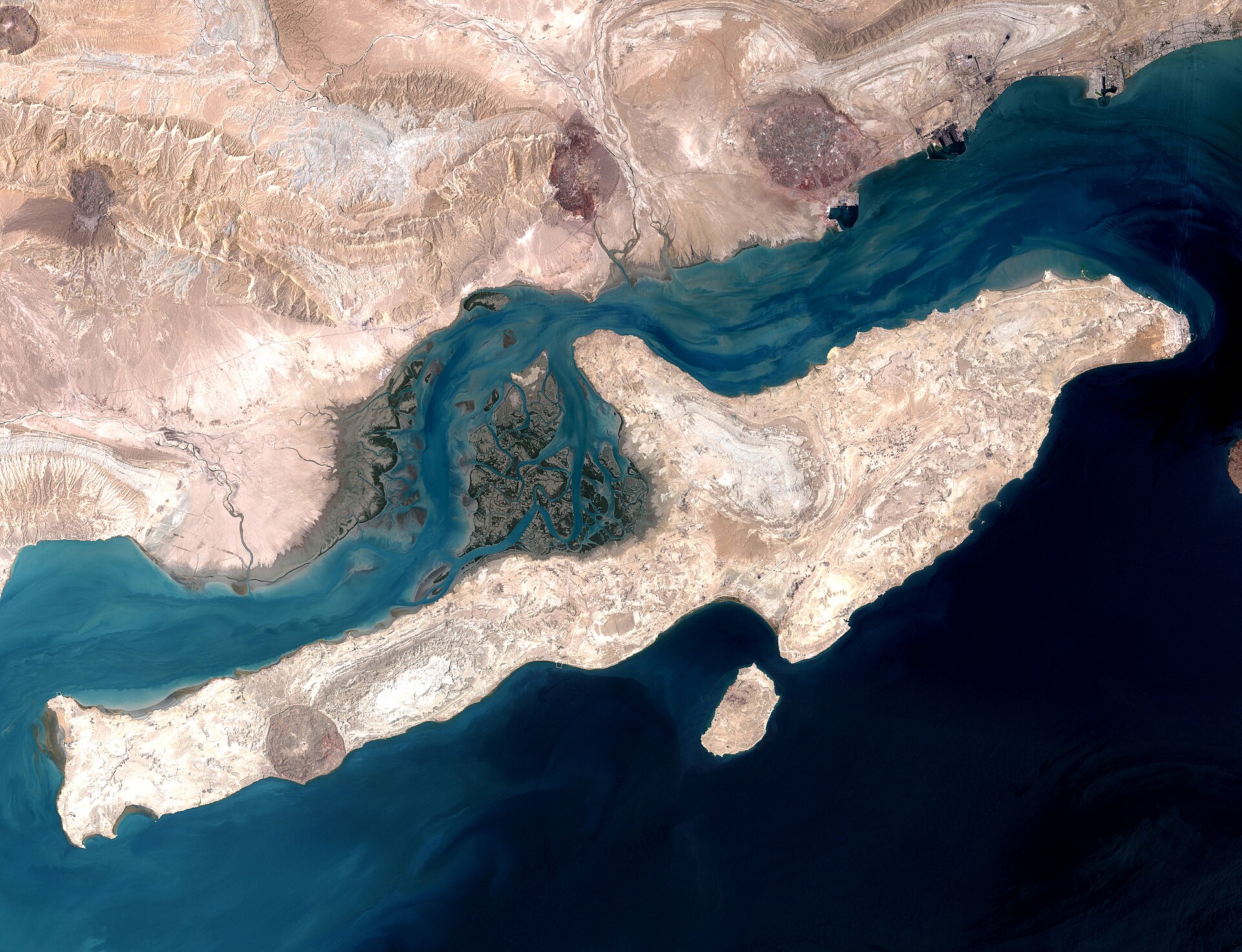 NASA satellite image of Qeshm Island in the Strait of Hormuz, showing the narrow waterway between Iran and the Omani exclave of Musandam