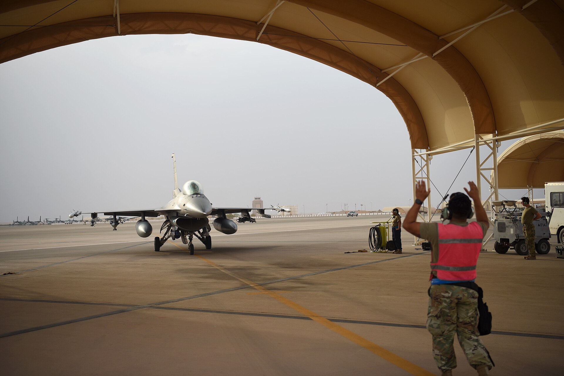 A USAF F-16 Fighting Falcon is marshalled into position at Prince Sultan Air Base, Saudi Arabia, May 2021. The base is the focal point of the DIA's assessment that Chinese telecommunications infrastructure near Saudi defence installations poses a counterintelligence risk for F-35 integration.