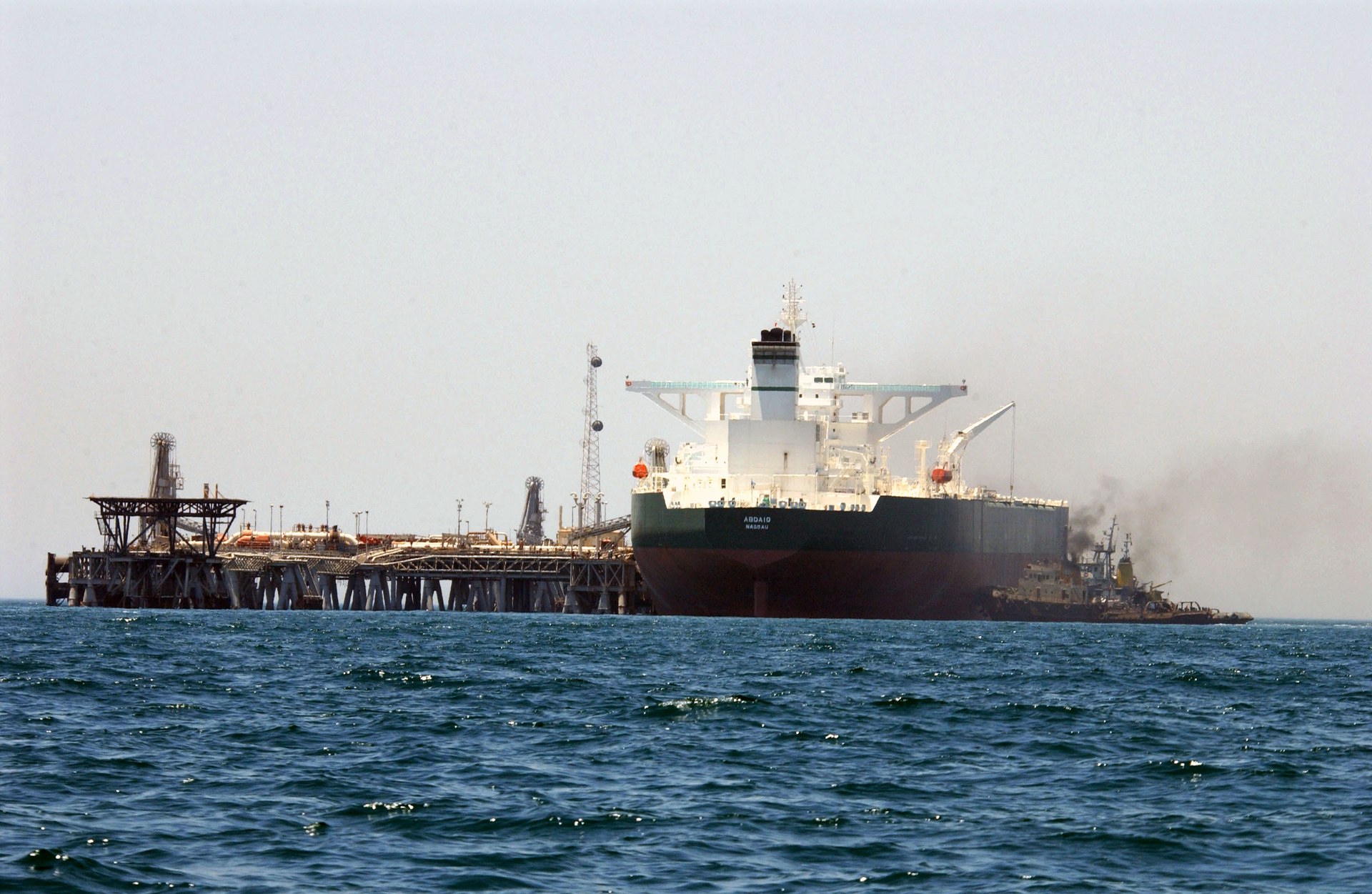 Crude oil tanker AbQaiq at an offshore Gulf loading terminal assisted by tugboats, Persian Gulf