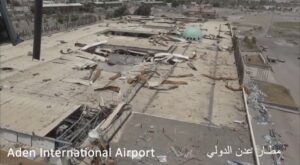 Aden International Airport terminal building gutted by war damage in July 2017, showing collapsed roof and debris across the entire structure
