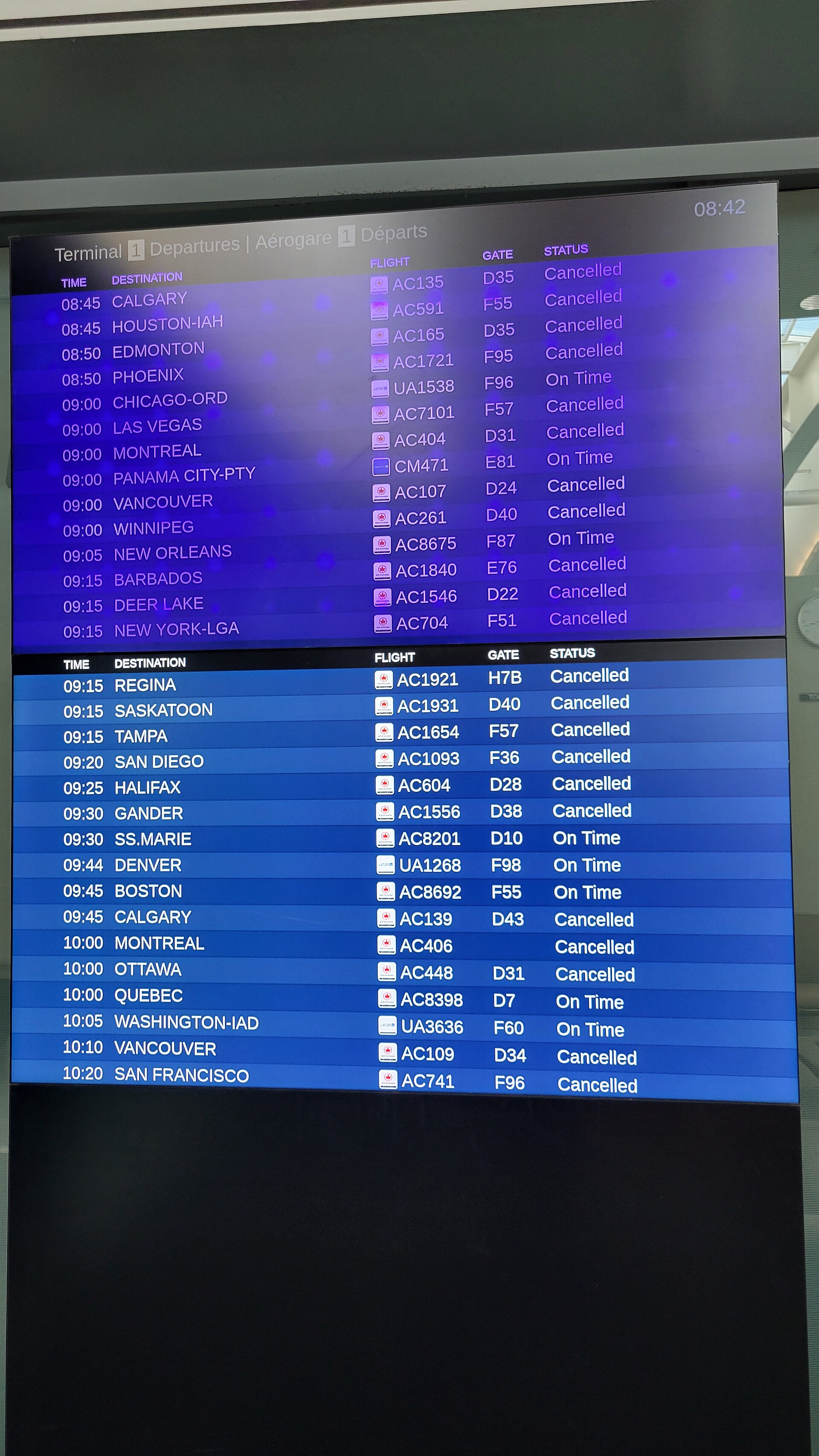 Airport departure board at Toronto Pearson showing almost all flights cancelled during the Air Canada strike, 2025