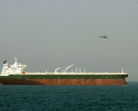 Aramco supertanker AbQaiq under US Navy helicopter escort in the Central Command area of the Arabian Gulf, 2003