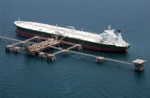 The supertanker Abqaiq loads crude oil at an offshore terminal in the Gulf — the same export chain whose Red Sea corridor now carries a three-million-dollar war-risk surcharge per voyage
