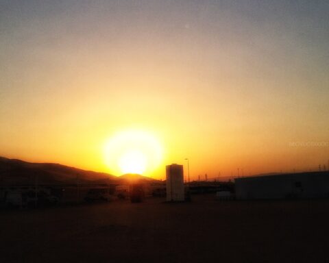 Shaybah oil field facility at sunset, Saudi Arabia — industrial infrastructure silhouetted against desert sky in the Rub al-Khali