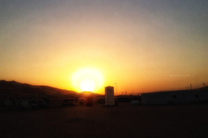 Shaybah oil field facility at sunset, Saudi Arabia — industrial infrastructure silhouetted against desert sky in the Rub al-Khali