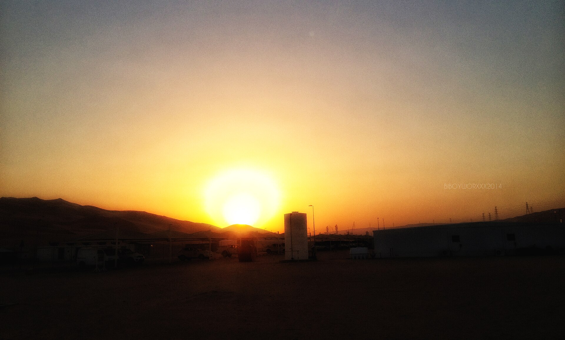Shaybah oil field facility at sunset, Saudi Arabia — industrial infrastructure silhouetted against desert sky in the Rub al-Khali
