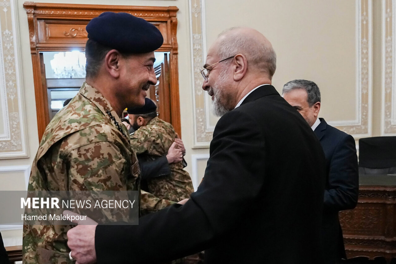 Field Marshal Asim Munir in Pakistan Army camouflage uniform greeting Iran parliament speaker Mohammad Baqir Qalibaf in Tehran, 2026