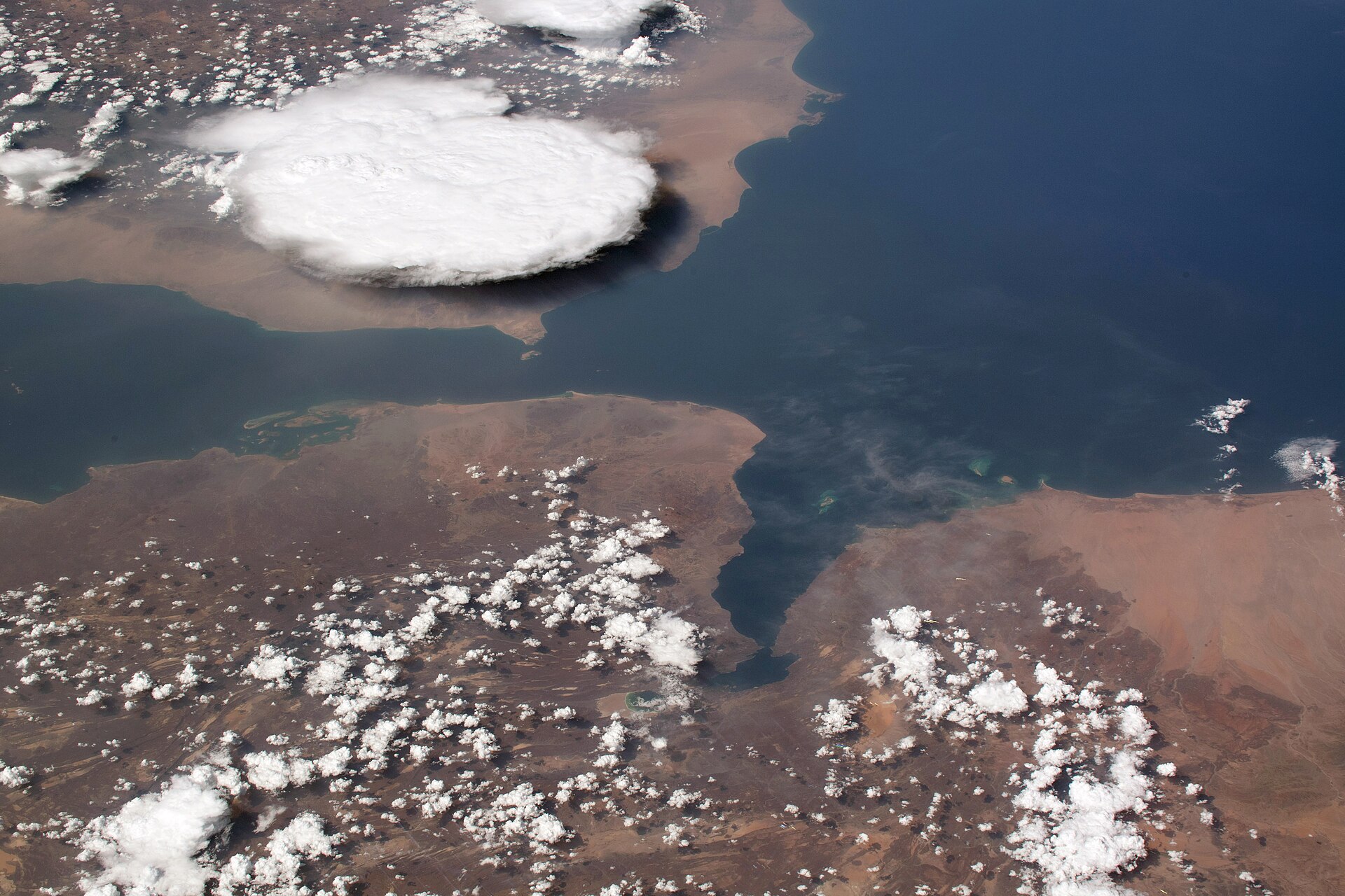 The Bab al-Mandab Strait photographed from the International Space Station at 254 miles altitude, showing Yemen flat coastal plain at right and Djibouti at left