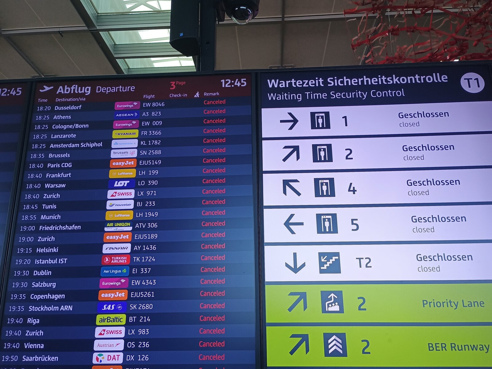 Berlin Brandenburg Airport Terminal 1 departure board showing all flights cancelled and all security lanes closed during March 2026 strike