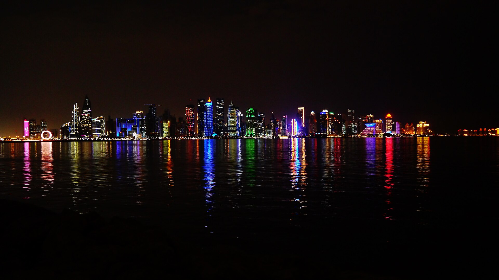 Doha skyline at night viewed from the Dhow Harbour corniche, Qatar