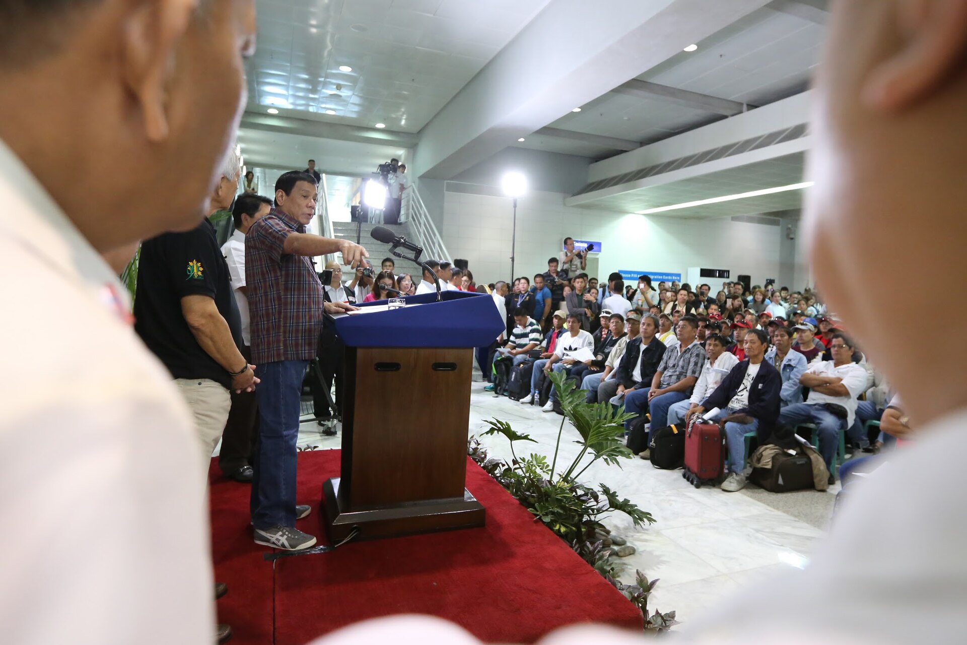 President Rodrigo Duterte addresses a gathering of repatriated overseas Filipino workers from Saudi Arabia at Ninoy Aquino International Airport, Manila