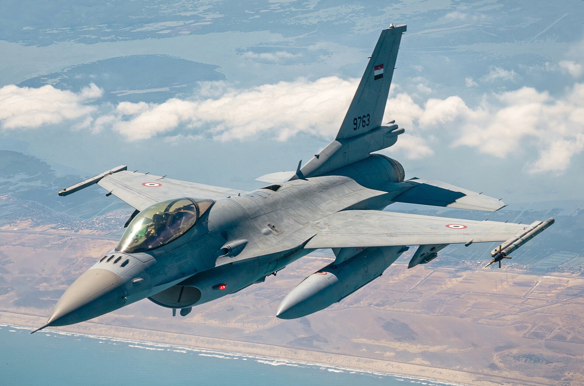 Egyptian Air Force F-16 fighter serial 9763 in flight with Egyptian roundels and flag during aerial exercise over Egypt