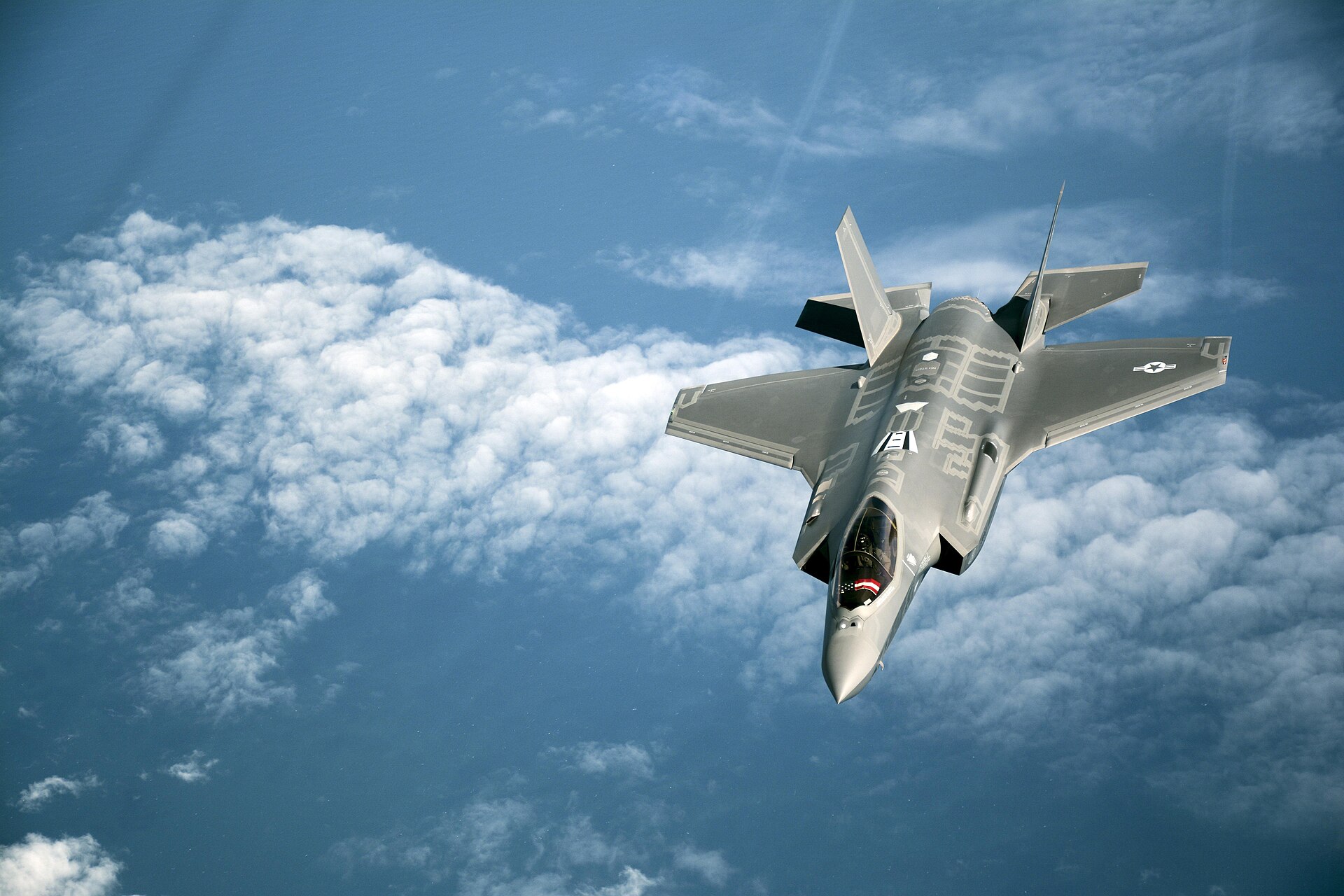 F-35A Lightning II stealth fighter jet in flight above clouds, US Air Force