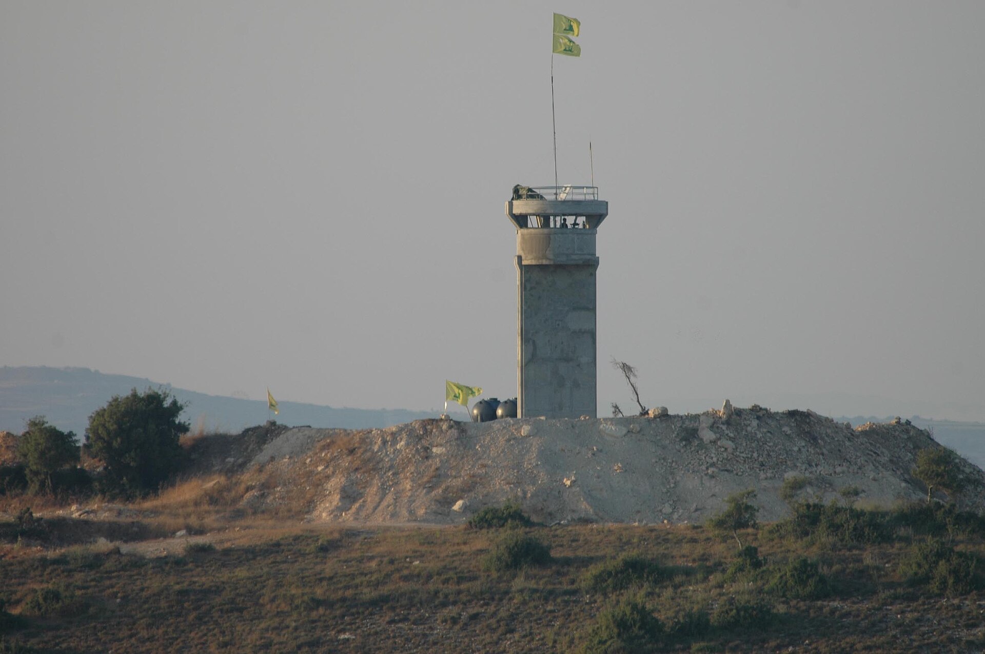 A Hezbollah observation post flying Hezbollah flags near the Israel-Lebanon border, photographed before an IDF airstrike during the July 2006 war
